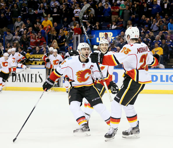 The Calgary Flames’ Mark Giordano, middle, celebrates with teammate Sean Monahan, right, after Monahan scored the game-winning goal in overtime against the St. Louis Blues on Saturday, March 25, 2017, at the Scottrade Center in St. Louis. Calgary won, 3-2, in overtime. (Chris Lee/St. Louis Post-Dispatch/TNS via Getty Images)