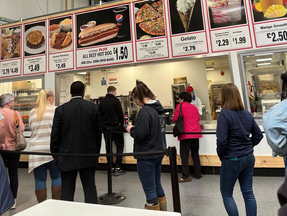 People waiting in a long line at UK Costco food court