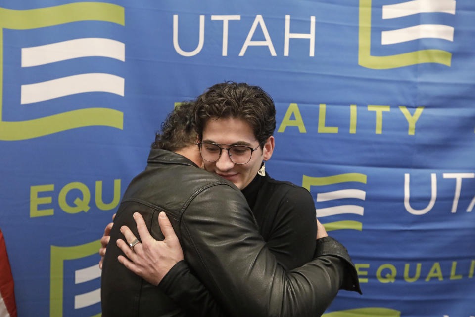Justin Utley, left, and Nathan Dalley, right, hug following a news conference about the discredited practice of conversion therapy for LGBTQ children, now banned in Utah Wednesday, Jan. 22, 2020, at the Utah State Capitol, in Salt Lake City. Utley and Dalley both under went so-called conversion therapy. (AP Photo/Rick Bowmer)