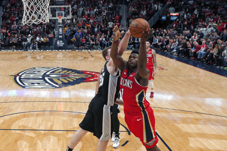 New Orleans Pelicans forward Zion Williamson (1) goes to the basket against San Antonio Spurs center Jakob Poeltl (25) in the second half of an NBA basketball game in New Orleans, Wednesday, Jan. 22, 2020. The Spurs won 121-117. (AP Photo/Gerald Herbert)