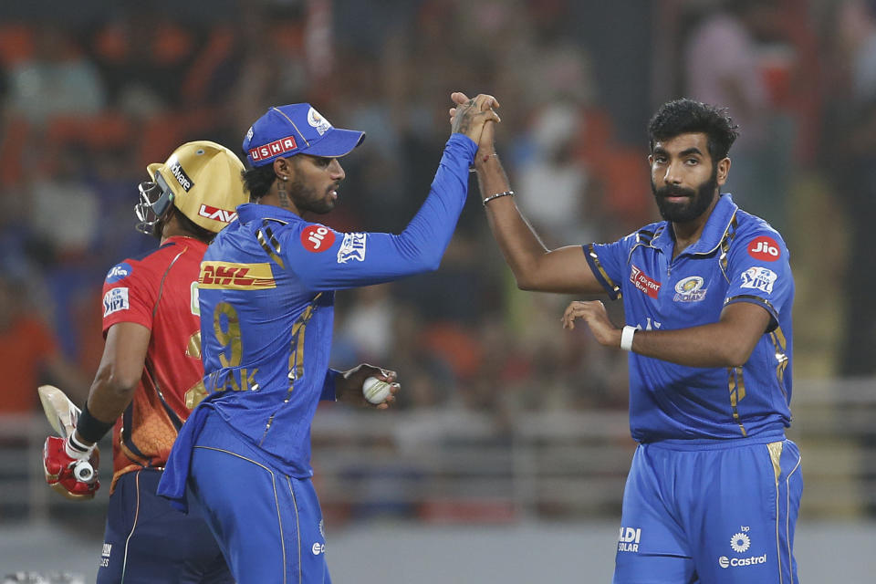 Mumbai Indians' Jasprit Bumrah , right, and Mumbai Indians' Tilak Varma celebrates the dismissal of Punjab Kings' Shashank Singh during the Indian Premier League cricket match between Punjab Kings' and Mumbai Indians' in Mullanpur ,India, Thursday, April 18, 2024.(AP Photo/ Surjeet Yadav))