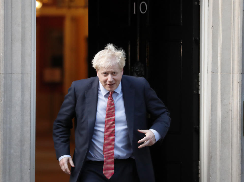 Britain's Prime Minister Boris Johnson leaves 10 Downing Street to welcome the President of the European Parliament David Sassol in London, Tuesday, Oct. 8, 2019.(AP Photo/Frank Augstein)