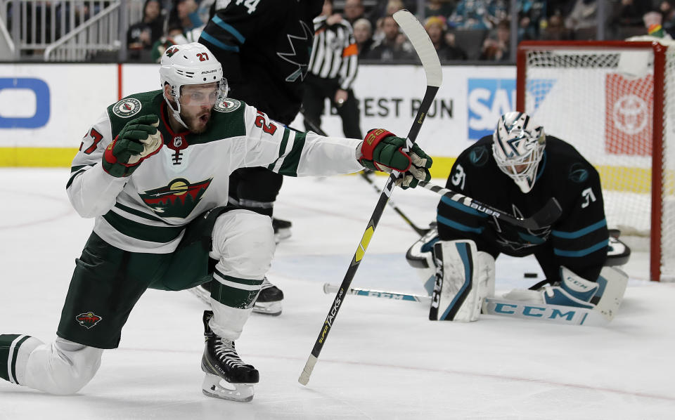 Minnesota Wild forward Alex Galchenyuk, left, celebrates after scoring a goal against San Jose Sharks' Martin Jones, right, in the second period of an NHL hockey game Thursday, March 5, 2020, in San Jose, Calif. (AP Photo/Ben Margot)