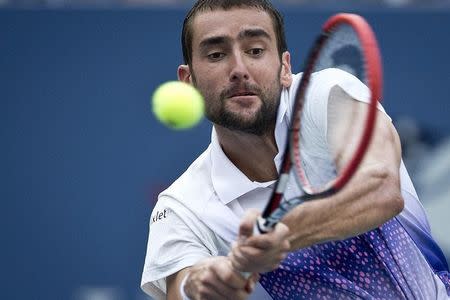 Marin Cilic of Croatia hits a return shot to Jo-Wilfried Tsonga of France during their quarterfinals match at the U.S. Open Championships tennis tournament in New York, September 8, 2015. REUTERS/Carlo Allegri