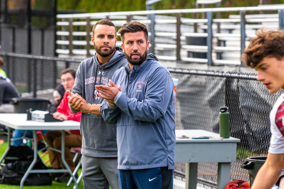 Bishop Stang coach Nate Greene looks down the sidelines during a boys soccer game last fall.