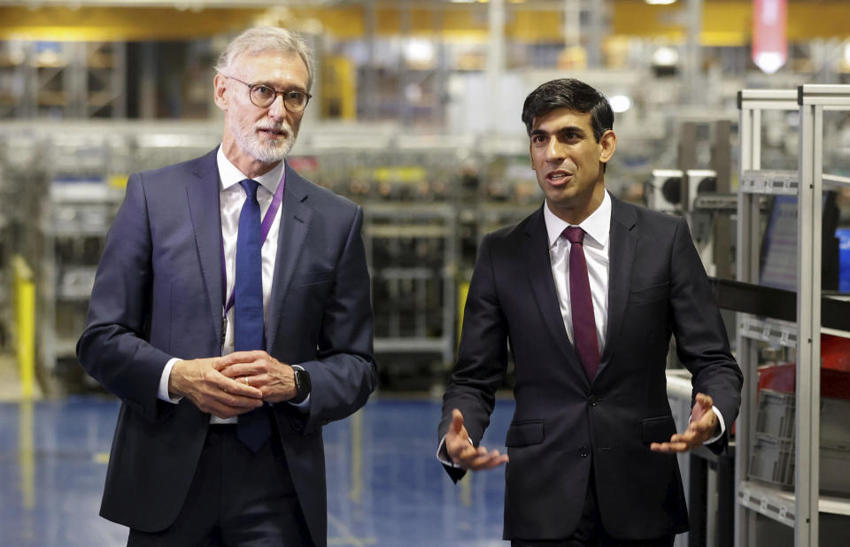 Britain's Chancellor of the Exchequer Rishi Sunak talks with the CEO of Worcester Bosch, Carl Arntzen, left, during a visit to Worcester Bosch factory to promote the initiative, Plan for Jobs, in Worcester, England, Thursday July 9, 2020. (Phil Noble/Pool via AP)