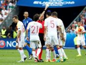 Football Soccer - Italy v Spain - EURO 2016 - Round of 16 - Stade de France, Saint-Denis near Paris, France - 27/6/16 Referee Cuneyt Cakir shows a yellow card to Spain's Sergio Busquets REUTERS/Christian Hartmann Livepic