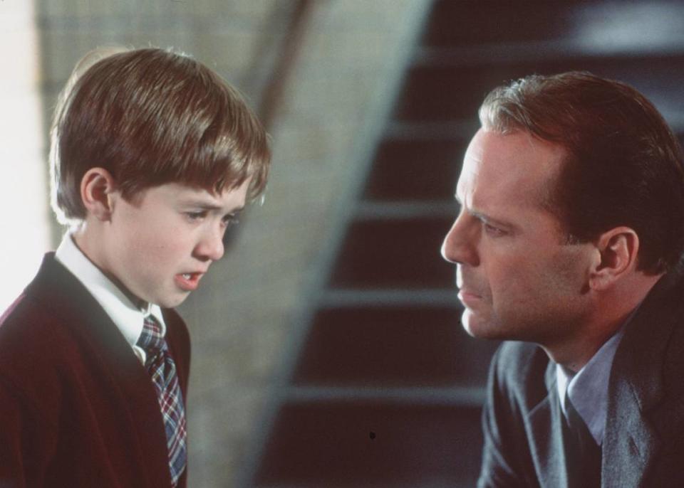 Haley Joel Osment, left, and Bruce Willis in “The Sixth Sense.” Charlotte author Sean O’Connell wrote a book detailing Willis’ career.