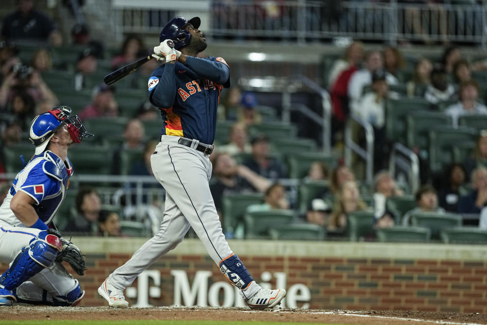 Houston Astros' Yordan Alvarez (44) watches after hitting a two-run home run in the sixth inning of a baseball game against the Atlanta Braves, Saturday, April 22, 2023, in Atlanta. (AP Photo/Brynn Anderson)