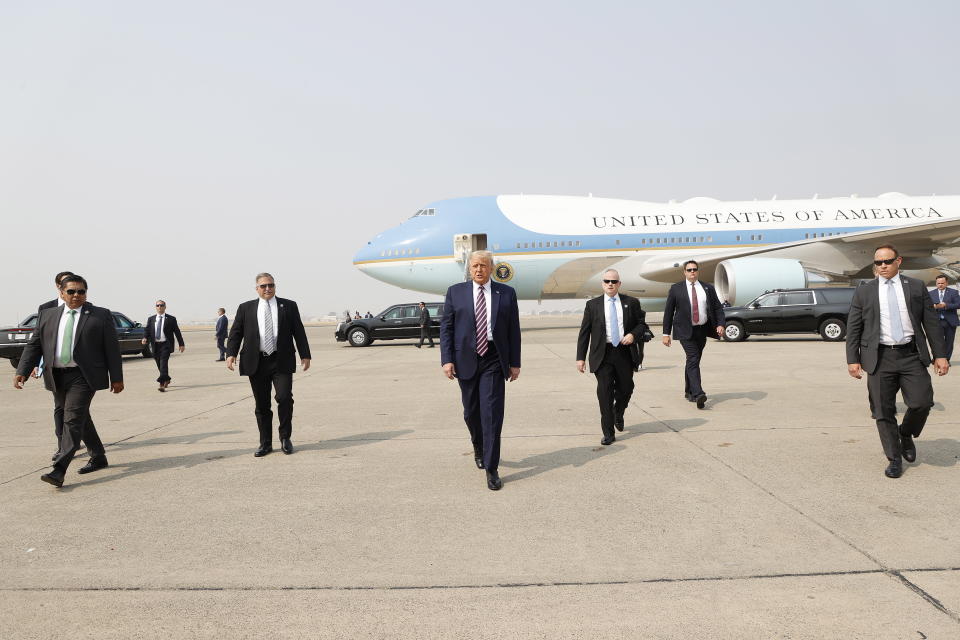 US President Donald Trump walks towards the media platform surrounded by his secret service detail. Source: AAP