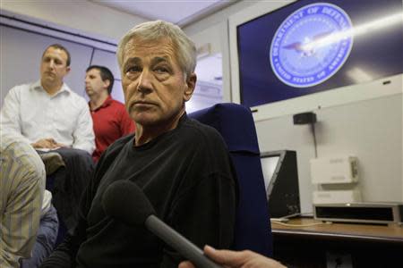 U.S. Defense Secretary Chuck Hagel turns to listen to a question from the travelling press aboard a U.S. military aircraft en route to Seoul, South Korea September 28, 2013. REUTERS/Jacquelyn Martin/Pool