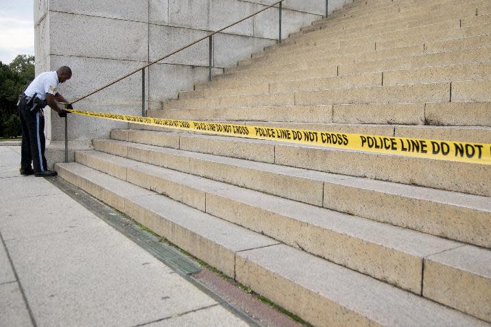 A US Park Police officer ties police tape to a hand rail closing access to the Lincoln Memorial in Washington, Tuesday, Oct. 1, 2013. Congress plunged the nation into a partial government shutdown Tuesday as a long-running dispute over President Barack Obama's health care law stalled a temporary funding bill, forcing about 800,000 federal workers off the job and suspending most non-essential federal programs and services. (AP Photo/Carolyn Kaster)