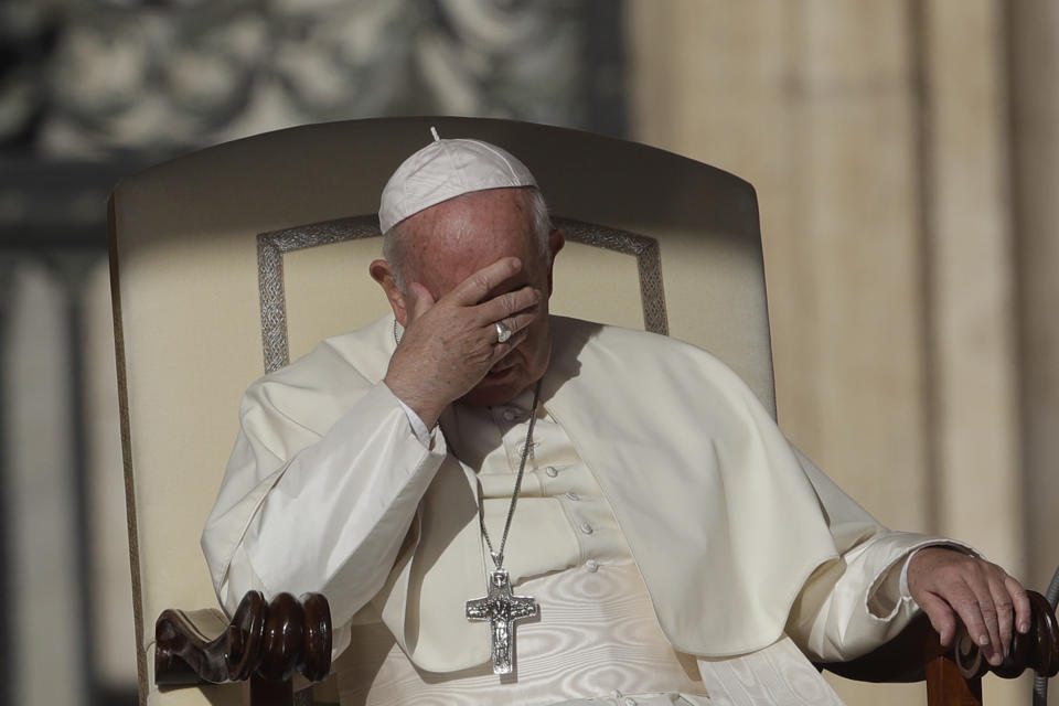 Pope Francis takes shelter from the sun as he sits in St. Peter's Square at the Vatican during his weekly general audience, Wednesday, Oct. 9, 2019. (AP Photo/Alessandra Tarantino)