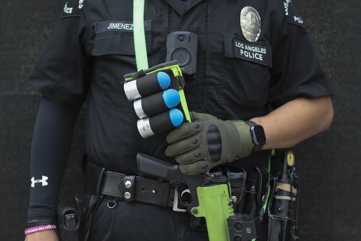 A police officer carrying a riffle stands guard during a protest on Nov. 6, 2020, in Los Angeles.