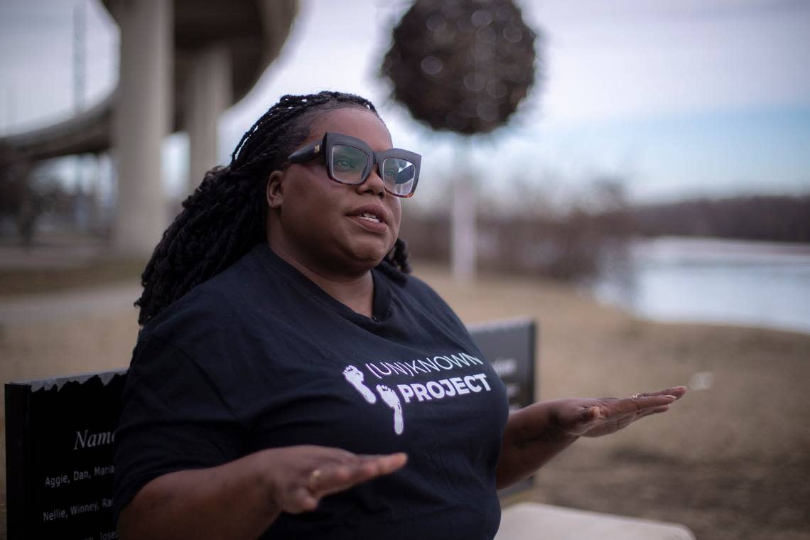 Hannah Drake is photographed by her (Un)Known Project installation near the Ohio River in downtown Louisville.