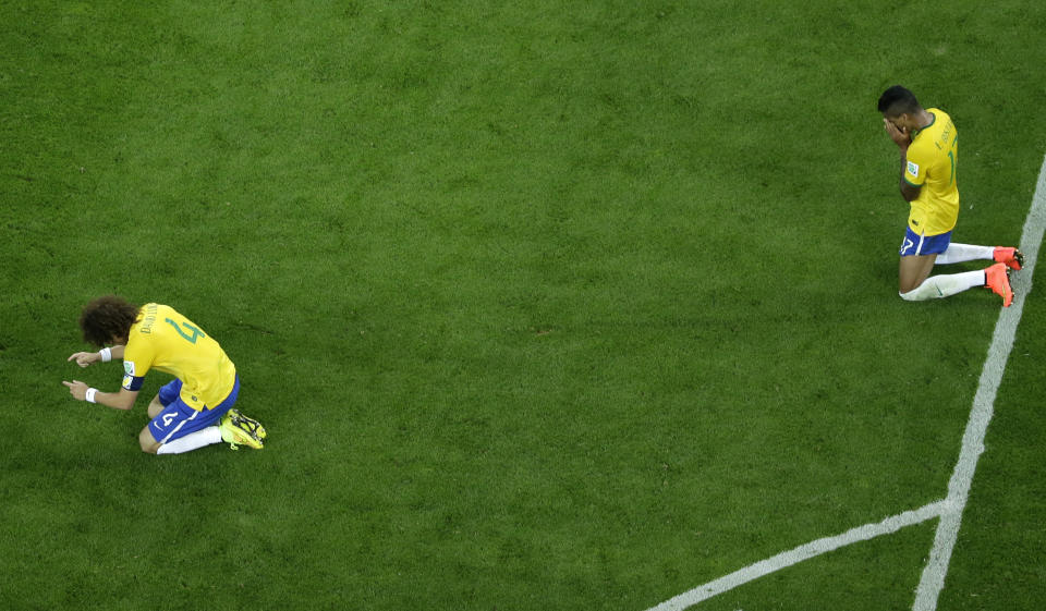 FILE - Brazil's David Luiz, left and Luiz Gustavo react after the World Cup semifinal soccer match between Brazil and Germany at the Mineirao Stadium in Belo Horizonte, Brazil, Tuesday, July 8, 2014. Germany has routed host Brazil 7-1 and advanced to the final of the World Cup. (AP Photo/Felipe Dana, Pool)