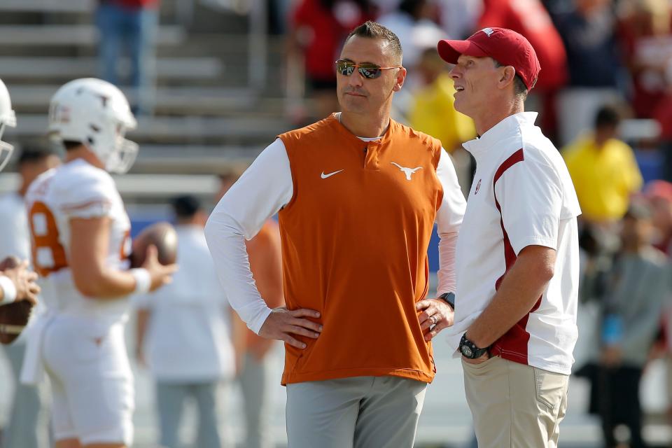 Oklahoma Sooners head coach Brent Venables, at right, and Texas Longhorns head coach Steve Sarkisian talk before the Red River Showdown college football game between the University of Oklahoma (OU) and Texas at the Cotton Bowl in Dallas, Saturday, Oct. 8, 2022.