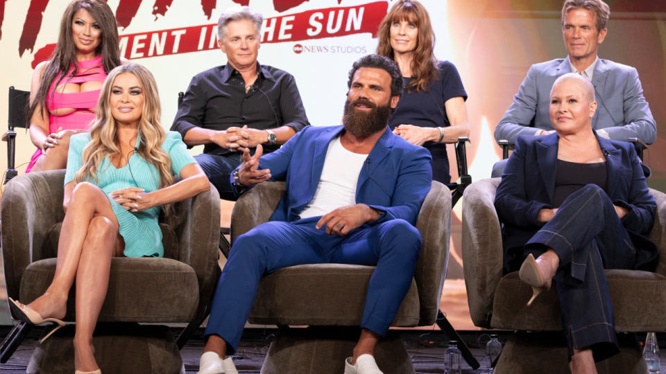     The Baywatch cast members sit together on stage during a reunion for a panel on After Baywatch: Moment in the Sun. 