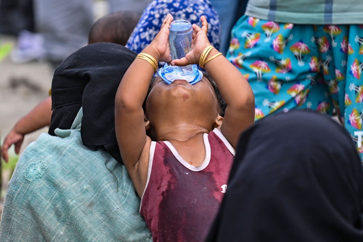 Representational image of a child in Indonesia drinking water (AFP via Getty Images)
