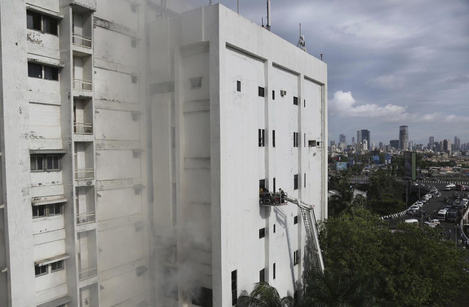 People are rescued from a nine-story building with offices of a state-run telephone company during a fire in Mumbai, India, Monday, July 22, 2019. (AP Photo/Rafiq Maqbool)