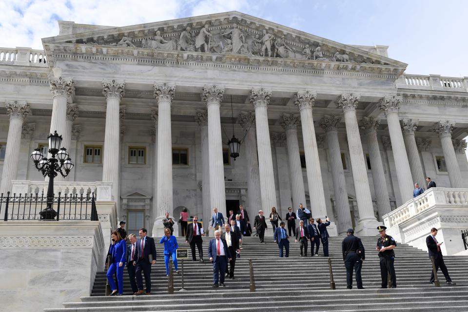 Members of the House of Representatives walk down the steps of Capitol Hill in Washington, Friday, March 27, 2020, after passing a coronavirus rescue package. Acting with exceptional resolve in an extraordinary time, the House rushed President Donald Trump a $2.2 trillion rescue package Friday, tossing a life preserver to a U.S. economy and health care system left flailing by the coronavirus pandemic. (AP Photo/Susan Walsh) ORG XMIT: DCSW128