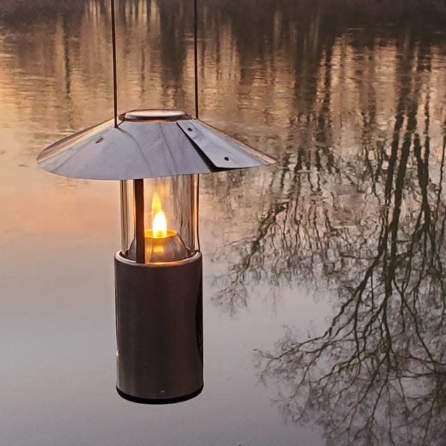 A UCO candle lantern casts a soft glow at a Mohican River campsite during a December canoe trip. Note the reflector on top the lantern, an optional accessory worth having.