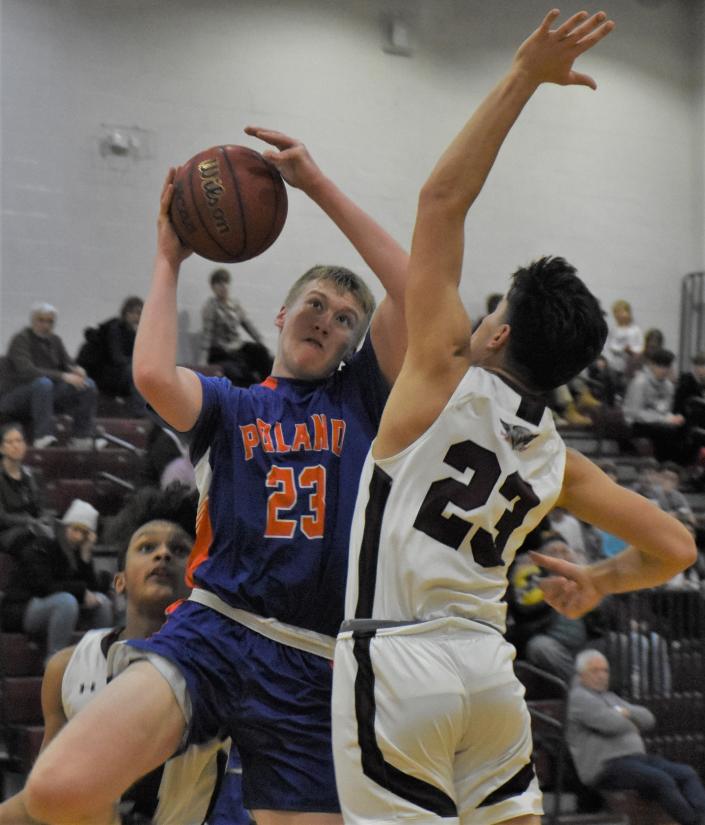 Poland Tornado Jackson Vail (23 in blue) prepares to shoot on his drive to the basket against Frankfort-Schuyler Maroon Knight Joshua Stemmer (23 in white).