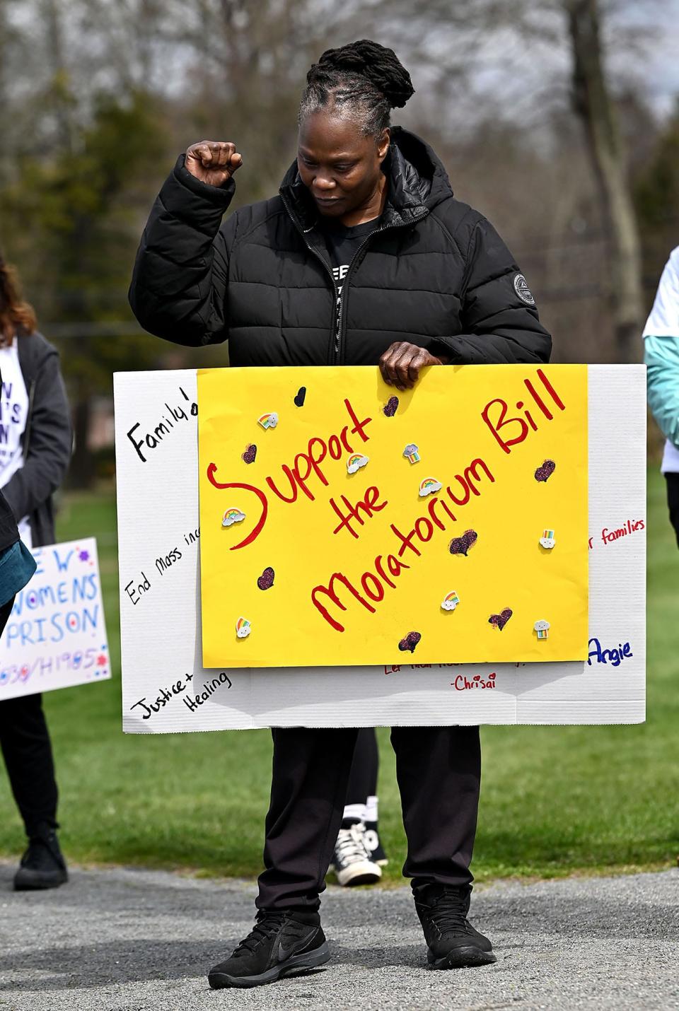 Pamela Starks, a Brockton resident and member of Families for Justice as Healing,  raises her fist as supporters of a prison construction moratorium rally on Framingham Centre Common, April 9, 2022. 