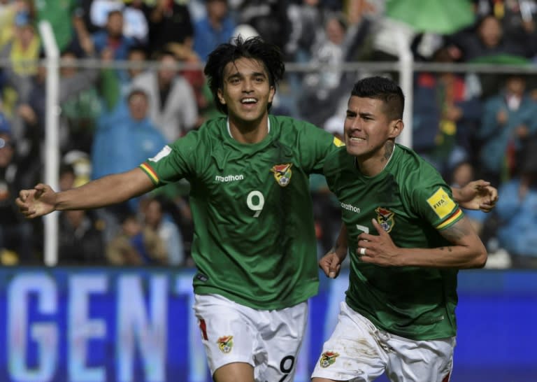 Bolivia's Juan Arce (R) celebrates with teammate Marcelo Martins after scoring a goal against Argentina during their Russia 2018 World Cup qualifier match, at Hernando Siles stadium in La Paz, on March 28, 2017