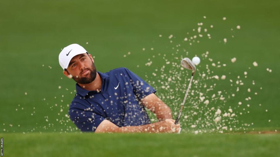 Scottie Scheffler playing out of a bunker during practice at Augusta National