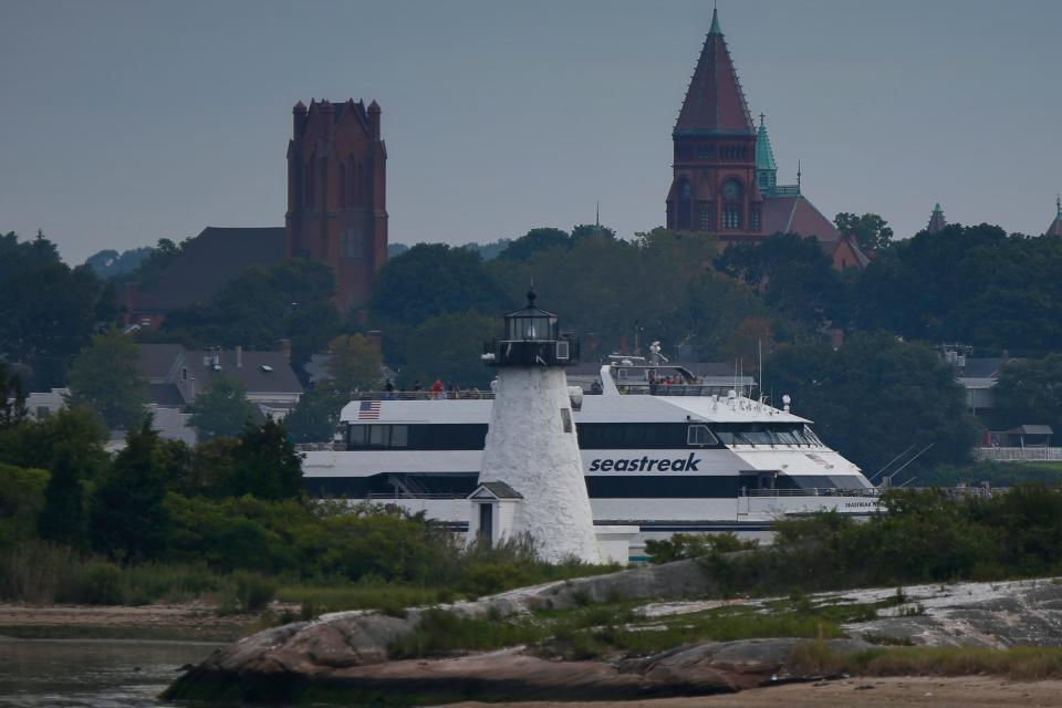 The Seastreak high speed ferry makes its way past the Palmers Island lighthouse as it heads out from New Bedford to Martha's Vineyard.