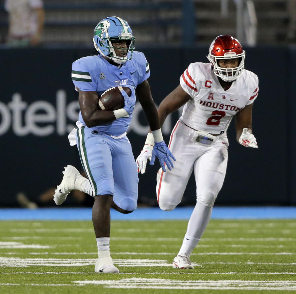 Tulane tight end Tyrick James (80) outruns Houston linebacker Deontay Anderson (2) for a long gain in the first half during an NCAA college football game in New Orleans, Thursday, Oct. 7, 2021. (A.J. Sisco/The Advocate via AP)