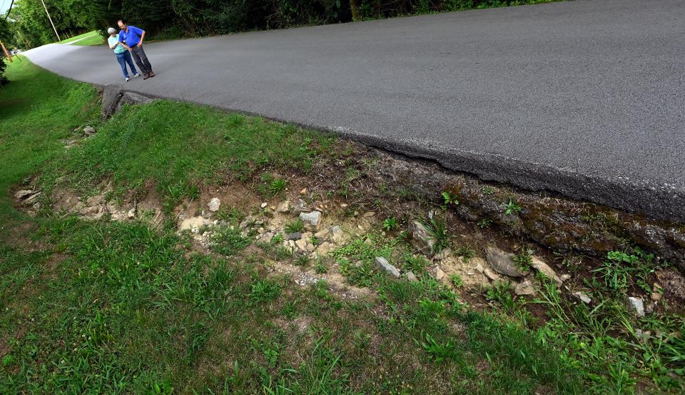 Reba Wittenmeire, left, and other neighbors are working with Barry Sulkin, right, an environmental consultant with Tennessee Riverkeeper, to resolve a debris mountain growing on private property in their neighborhood on Friday, June 23, 2023, in Scottsboro, Tenn. They are worried the runoff is eroding the roads in the neighborhood, including Old Hydes Ferry Pike.