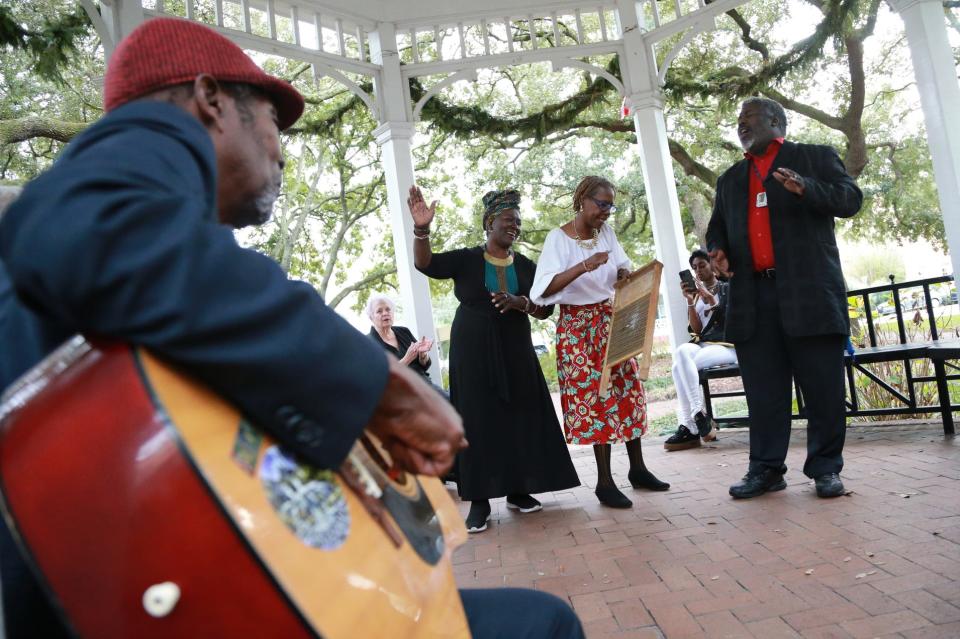 Randy Williams, standing right, and Patt Gunn, left, sing and dance Sunday during a Jubilee Freedom Day celebration at Whitefield Square.