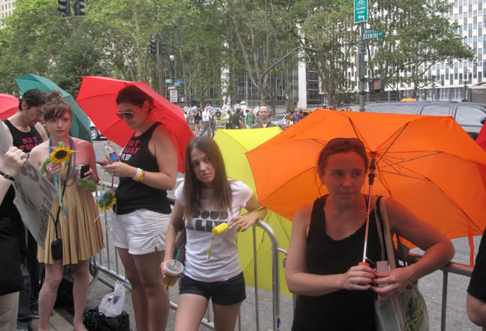 People used colorful umbrellas to shield same-sex couples from protesters. Joao Costa/Yahoo! News