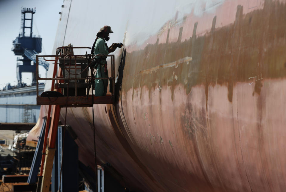 FILE — Welder Neal Larsen works on the hull of a Zumwalt-class destroyer Aug. 29, 2018, being built in the shipyard at Bath Iron Works in Bath, Maine. The U.S. Navy, following costly lessons after cramming too much new technology onto warships and speeding them into production, is slowing down the design and purchase of its next-generation destroyer, and taking extra steps to ensure new technology like lasers and hypersonic missiles have matured before pressing ahead. (AP Photo/Robert F. Bukaty, File)