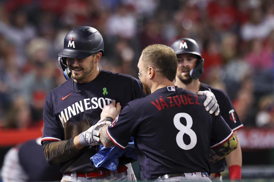 Minnesota Twins Trevor Larnach celebrates with Christian Vazquez (8) after scoring off of a throwing error by Los Angeles Angels second baseman Brandon Drury during the seventh inning of a baseball game in Anaheim, Calif., Saturday, May 20, 2023. (AP Photo/Jessie Alcheh)