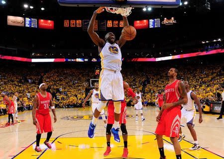 May 27, 2015; Oakland, CA, USA; Golden State Warriors center Festus Ezeli (31) dunks as Houston Rockets forward Trevor Ariza (1) looks on during the fourth quarter in game five of the Western Conference Finals of the NBA Playoffs at Oracle Arena. Kyle Terada-USA TODAY Sports