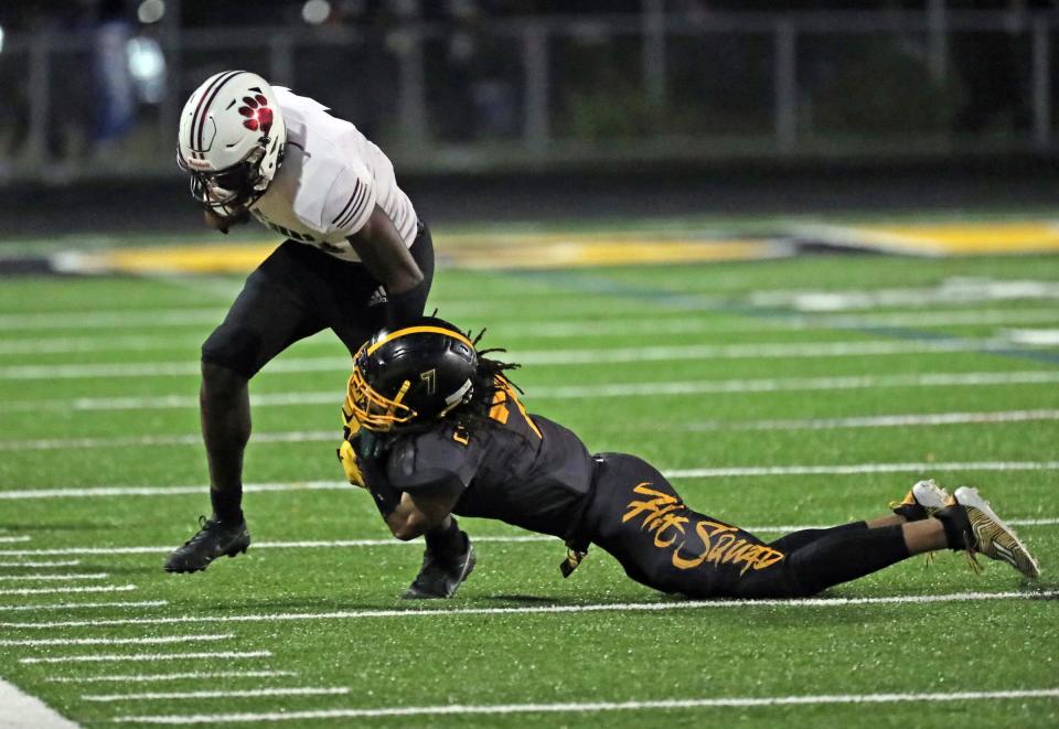 River Rouge wide receiver Nicholas Marsh (11) is tackled by Detroit King DE Jameel Croft Jr. (7) during first-half action on Friday, Oct. 28, 2022.