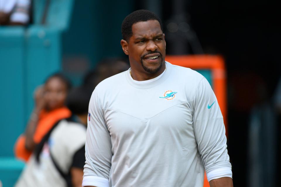 Miami Dolphins outside linebackers coach Ty McKenzie walks onto the field before an NFL football game against the Houston Texans, Sunday, Nov. 27, 2022, in Miami Gardens, Fla. (AP Photo/Doug Murray)