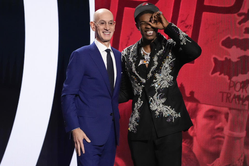 Scoot Henderson, right, reacts with NBA Commissioner Adam Silver watching after being selected third overall by the Portland Trail Blazers during the NBA basketball draft Thursday, June 22, 2023, in New York. (AP Photo/John Minchillo)