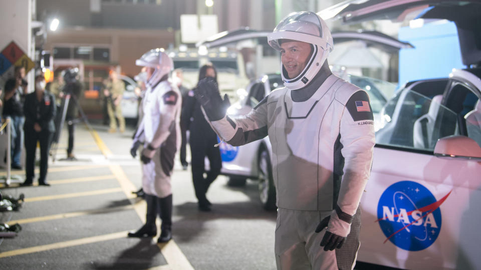 NASA astronaut Kjell Lindgren waves to family and friends as he and crew mates, NASA astronauts Robert Hines, Jessica Watkins, and ESA (European Space Agency) astronaut Samantha Cristoforetti, wearing SpaceX spacesuits, depart the Neil A. Armstrong Operations and Checkout Building for Launch Complex 39A to board the SpaceX Crew Dragon spacecraft for the Crew-4 mission launch, Tuesday, April 26, 2022, at NASA’s Kennedy Space Center in Florida.