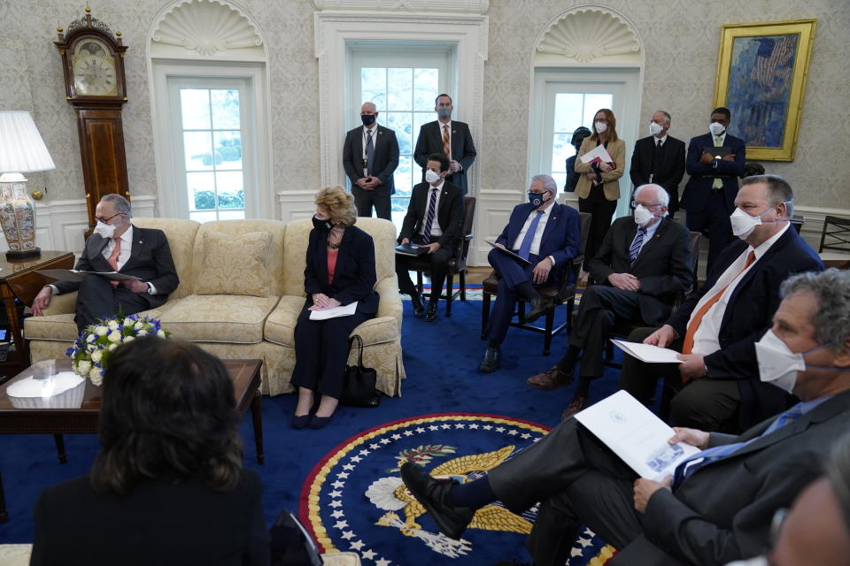 FILE - In this Feb. 3, 2021, file photo President Joe Biden and Vice President Kamala Harris meet with Senate Majority Leader Sen. Chuck Schumer of N.Y., left, and other Democratic lawmakers to discuss a coronavirus relief package, in the Oval Office of the White House in Washington. Biden’s push for a giant COVID-19 relief bill is forcing an internal reckoning that pits his instincts to work toward a bipartisan deal against the demands of an urgent crisis and his desire to deliver for those who helped elect him. (AP Photo/Evan Vucci, File)