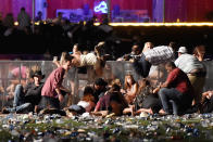 <p>People scramble for shelter at the Route 91 Harvest country music festival after apparent gun fire was heard on Oct. 1, 2017 in Las Vegas. (Photo: David Becker/Getty Images) </p>