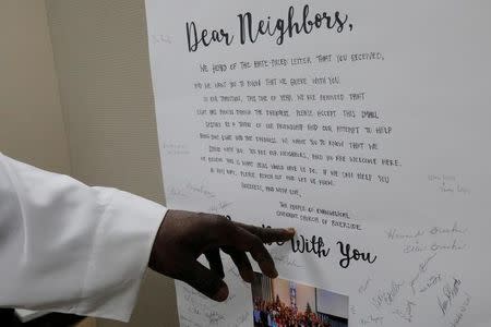 Imam Abdul-Latif Sackor points to a letter of support from "The People of Evangelical Covanent Church of Riverside" sent after hate letters were received at the Islamic Center of Rhode Island, Masjid Al-Kareem Mosque in Providence, Rhode Island, U.S., May 4, 2017. Picture taken May 4, 2017. REUTERS/Brian Snyder