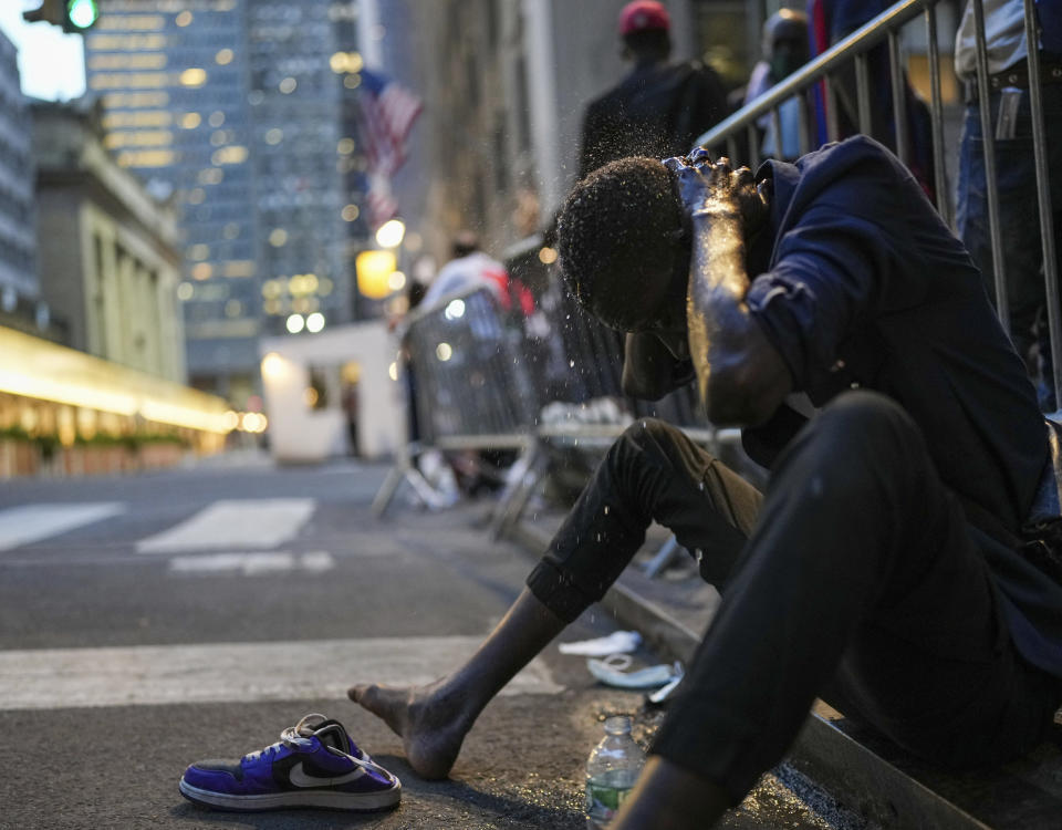 Asylum Seekers line the side walk of the Roosevelt Hotel passing time and sleeping in the endless sun as their cases wind through the legal hallways to find housing and work accommodations in New York City on August 2, 2023.