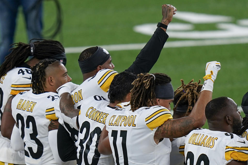 Pittsburgh Steelers players react during the national anthem before playing against the New York Giants in an NFL football game Monday, Sept. 14, 2020, in East Rutherford, N.J. (AP Photo/Seth Wenig)