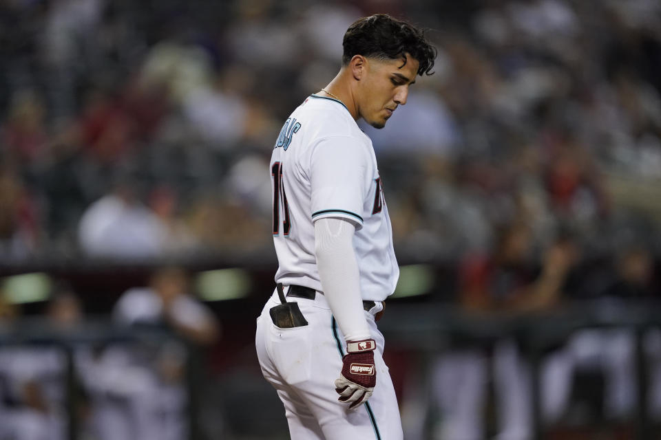 Arizona Diamondbacks' Josh Rojas walks to the dugout after striking out against the Cincinnati Reds during the sixth inning of a baseball game, Tuesday, June 14, 2022, in Phoenix. (AP Photo/Matt York)