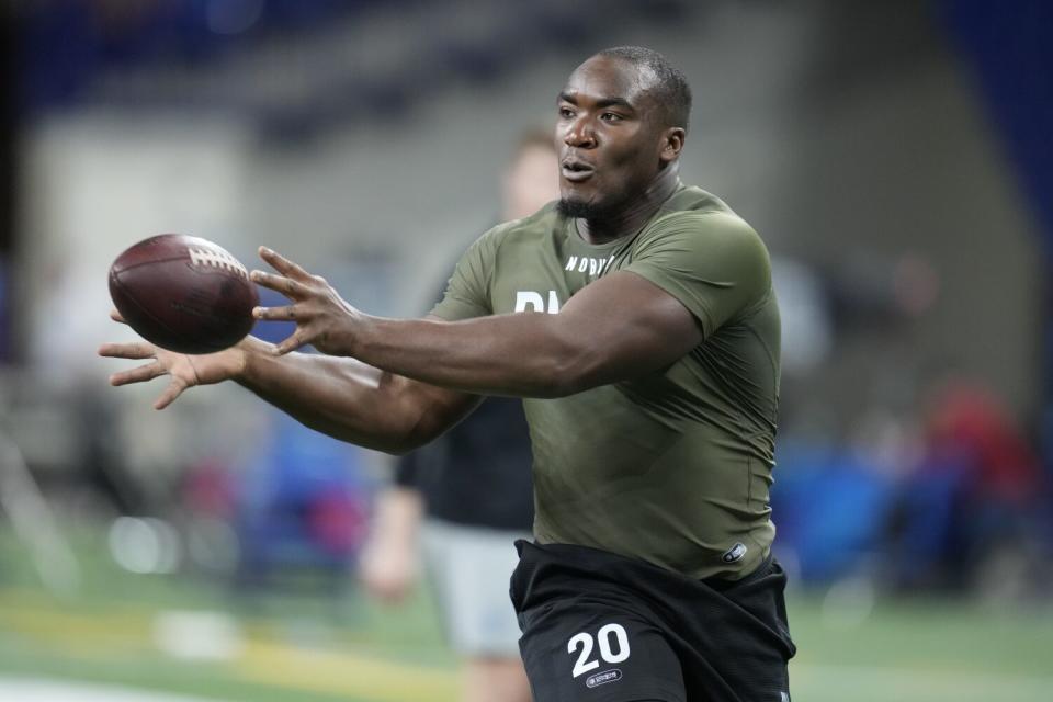 Northwestern defensive lineman Adetomiwa Adebawore runs a drill at the NFL scouting combine in March.
