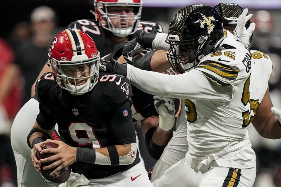 New Orleans Saints defensive end Carl Granderson (96) grabs Atlanta Falcons quarterback Desmond Ridder (9) during the first half of an NFL football game, Sunday, Nov. 26, 2023, in Atlanta. (AP Photo/Brynn Anderson)